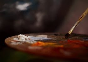 pexels-photo-2219040-2219040 Close-up of an artist's palette with vibrant paints and a brush for creative expression.